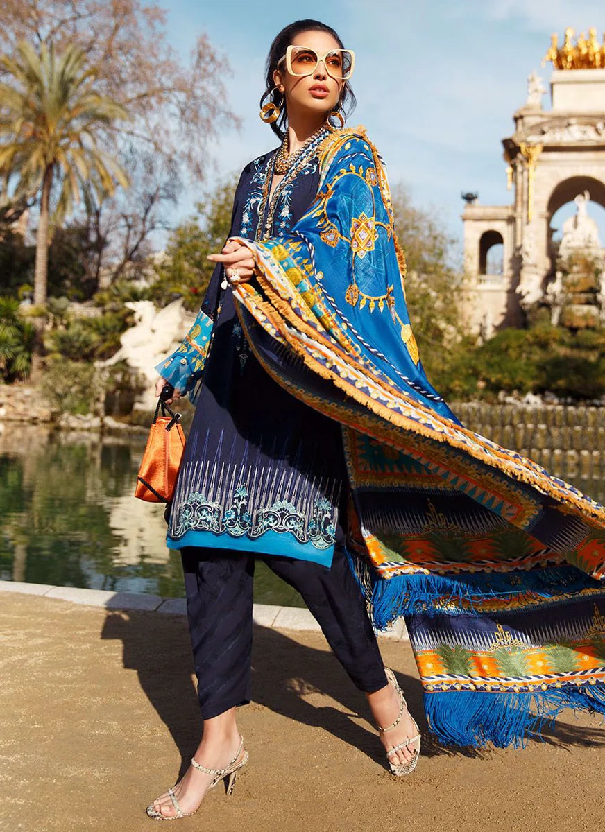 A woman wearing a traditional Indian outfit with a blue and gold patterned kurta and matching skirt, holding a large wooden board or prop, set against a blurred outdoor background.