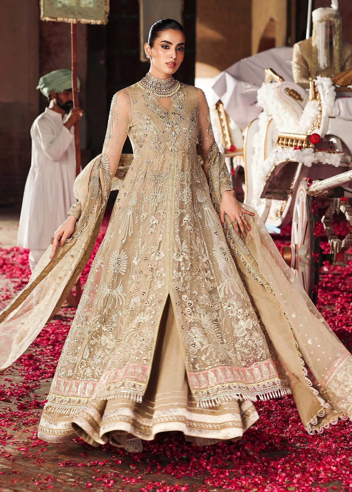 Woman in a traditional embroidered dress standing on a red carpet with decorative elements.