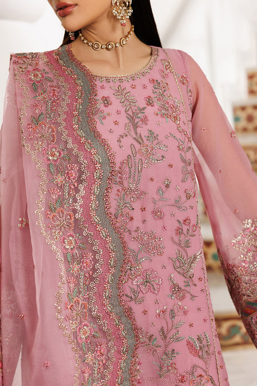 Pink embroidered traditional outfit with intricate designs on a blurred background