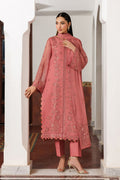 Woman wearing a pink embroidered outfit in an elegant interior setting