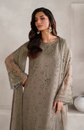 Woman wearing a beige embroidered outfit with a matching dupatta against a white background