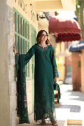 Woman in a long green dress standing on a street corner