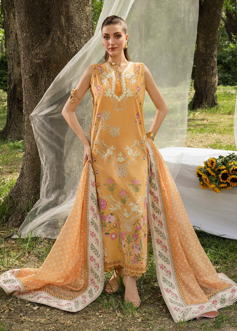 Woman in a traditional outfit with floral patterns standing outdoors near a tree.