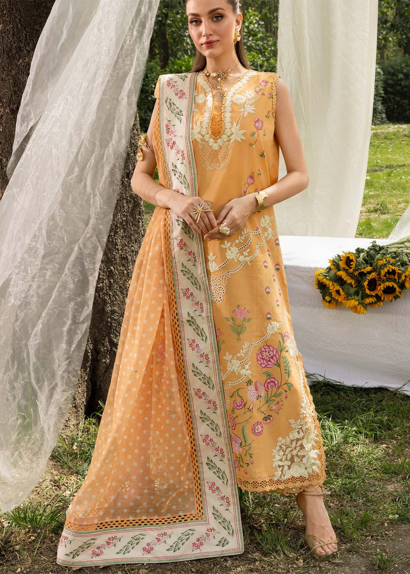 Woman wearing a traditional yellow and white embroidered outfit in an outdoor setting.