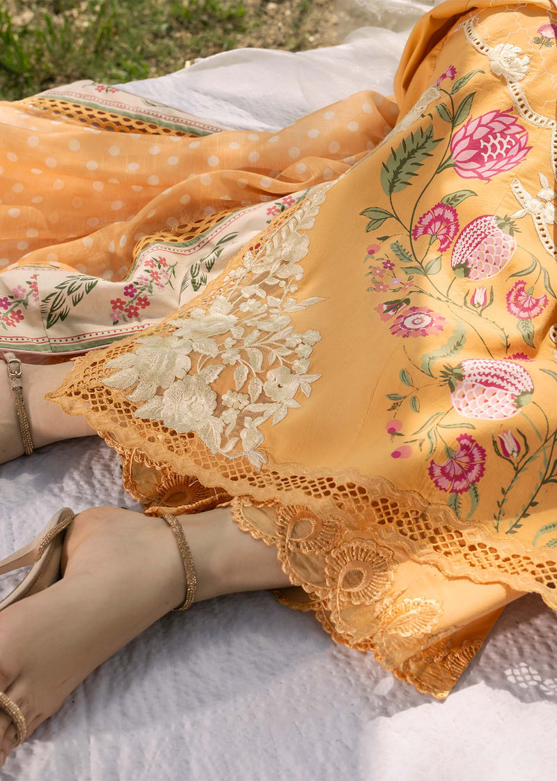 Yellow embroidered fabric with floral patterns on a white surface