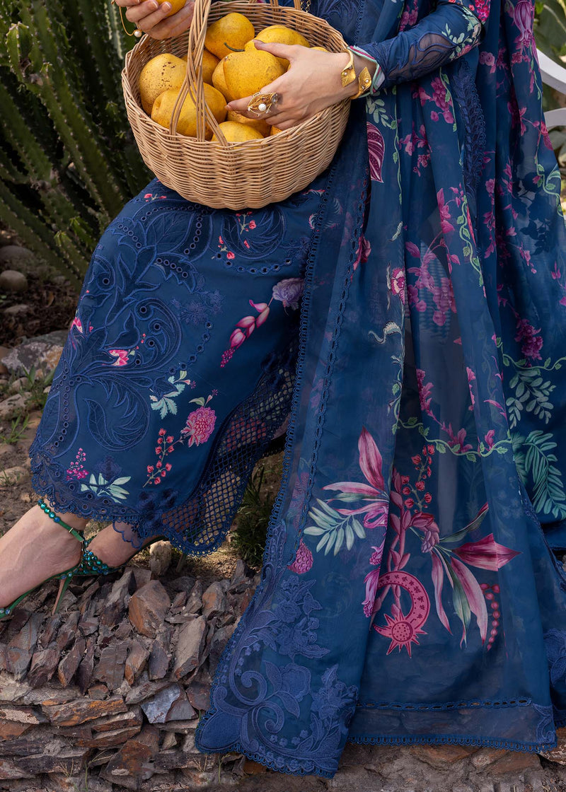Person holding a basket of lemons wearing a blue floral dress.