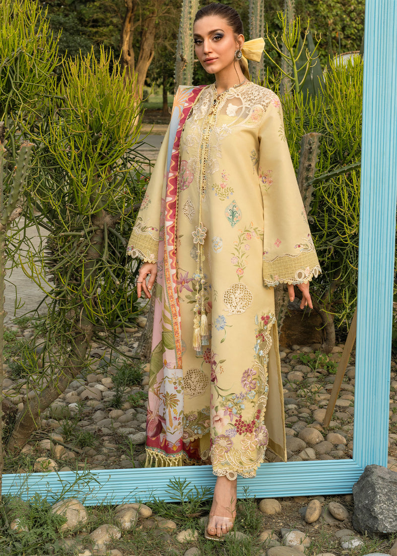 Woman in a beige embroidered outfit standing in front of a mirror with a garden background