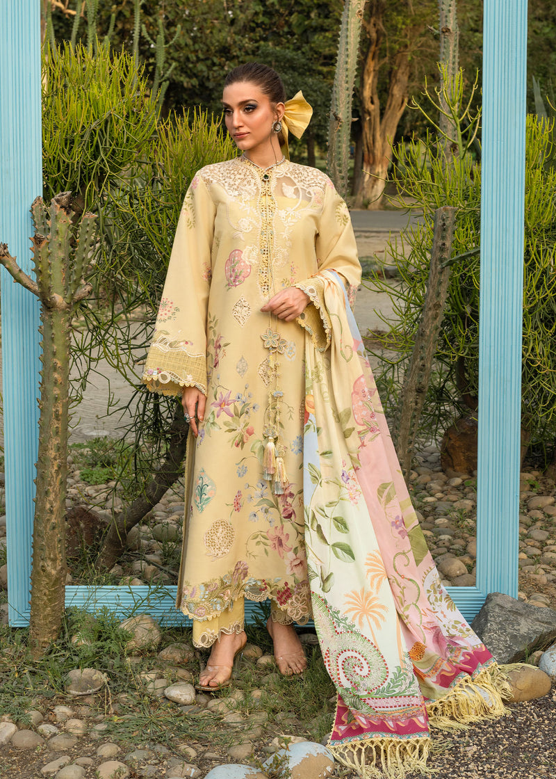 Woman in a beige embroidered outfit with a colorful scarf standing outdoors.