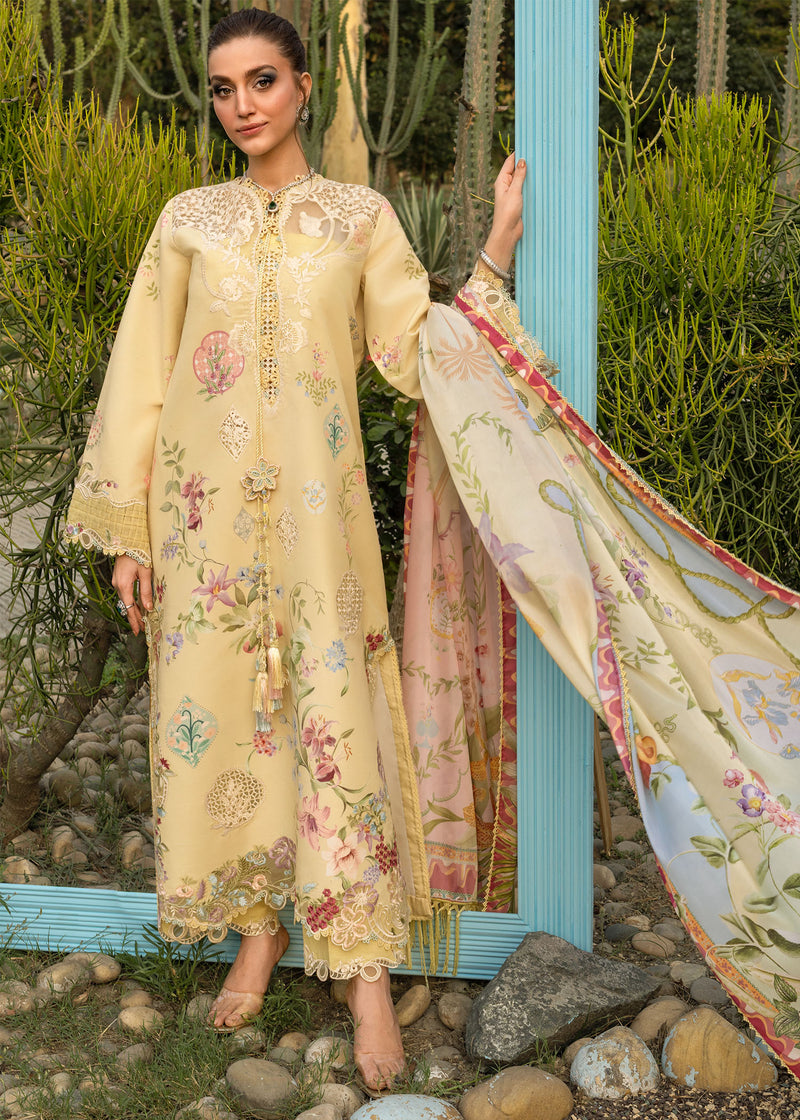 Woman in a beige embroidered outfit with a floral dupatta standing outdoors.