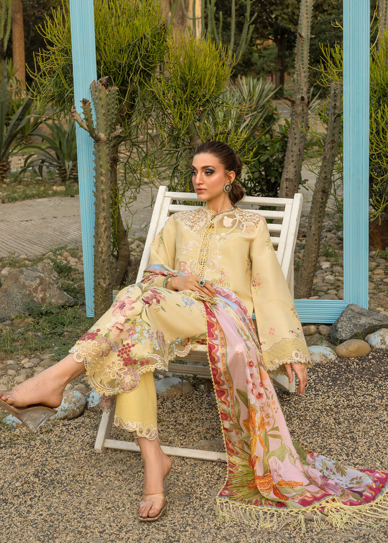 Woman in a light-colored outfit with a floral scarf sitting on a white chair in a garden setting.
