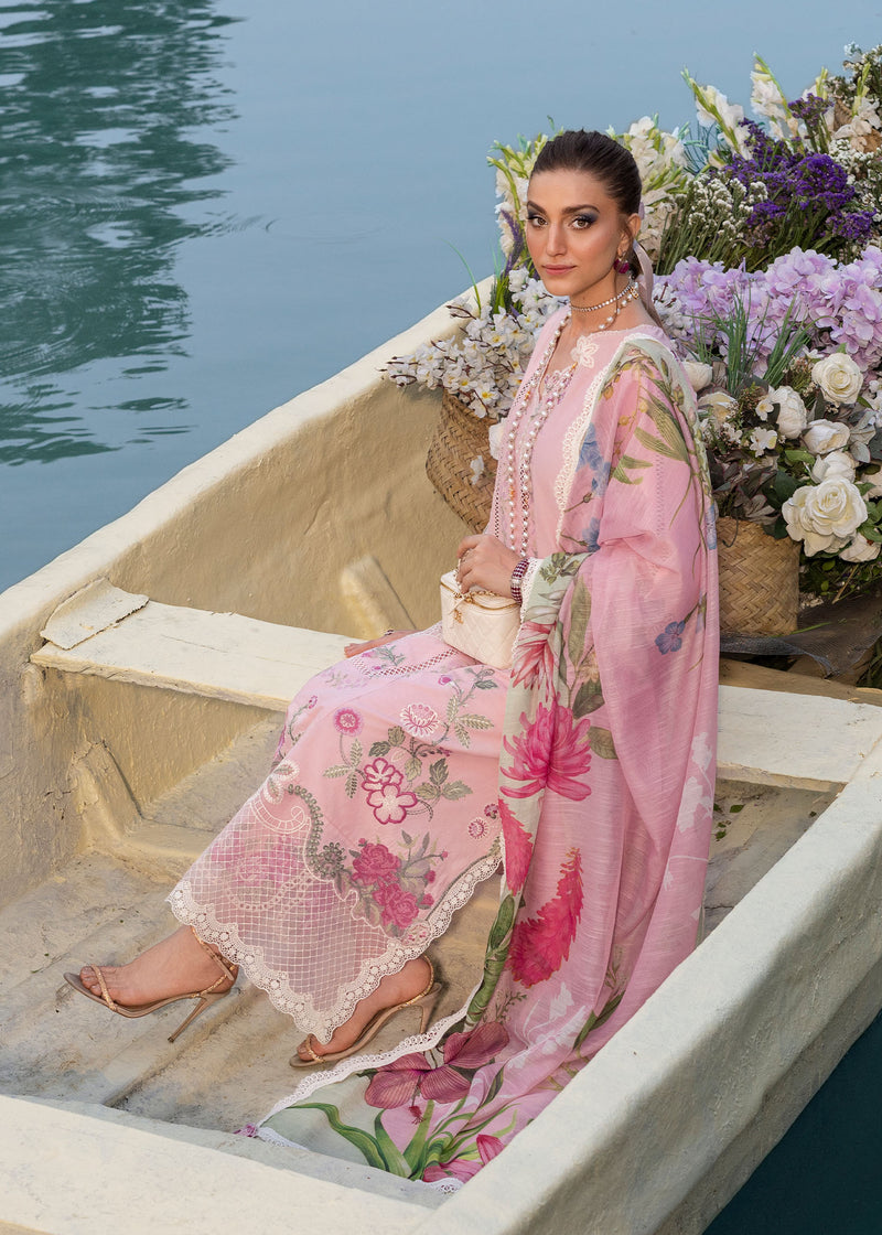 Woman in a floral dress sitting on a boat with flowers and water in the background