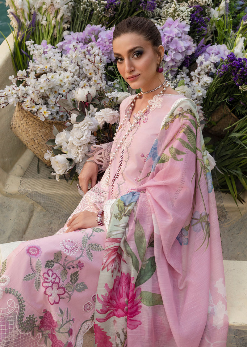 Woman in a pink floral outfit sitting among flowers