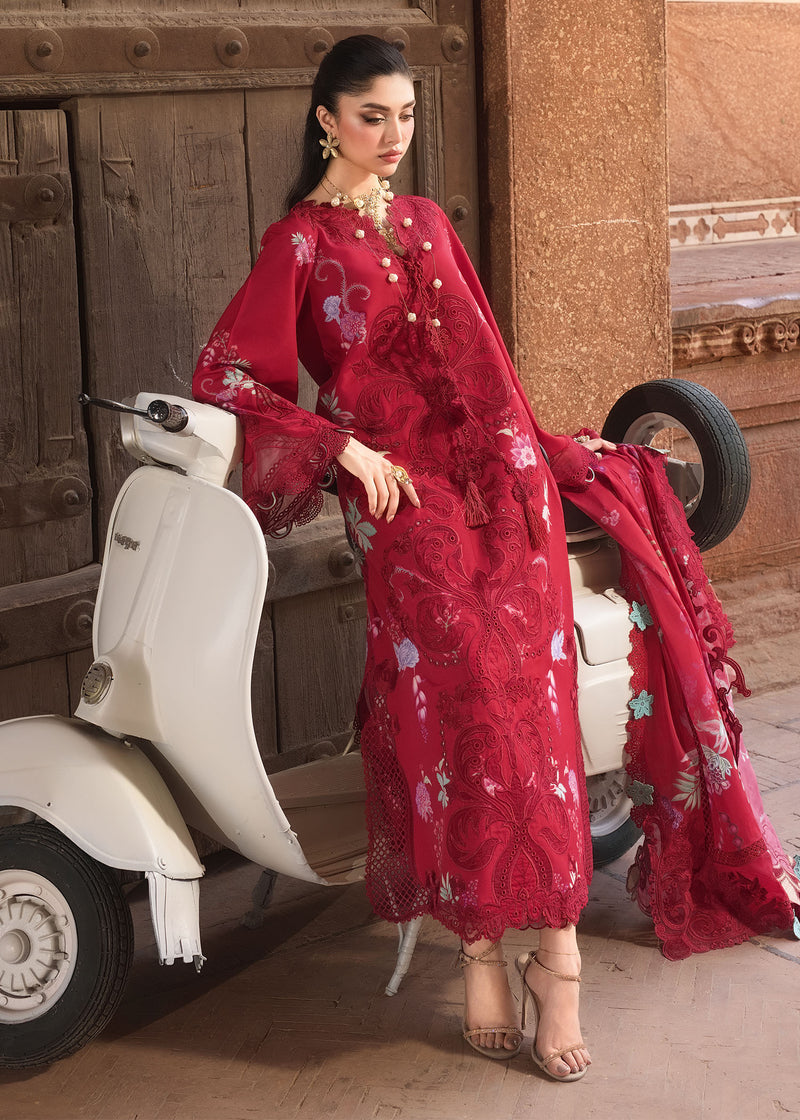 Woman in a red floral dress sitting on a white scooter with a wooden background