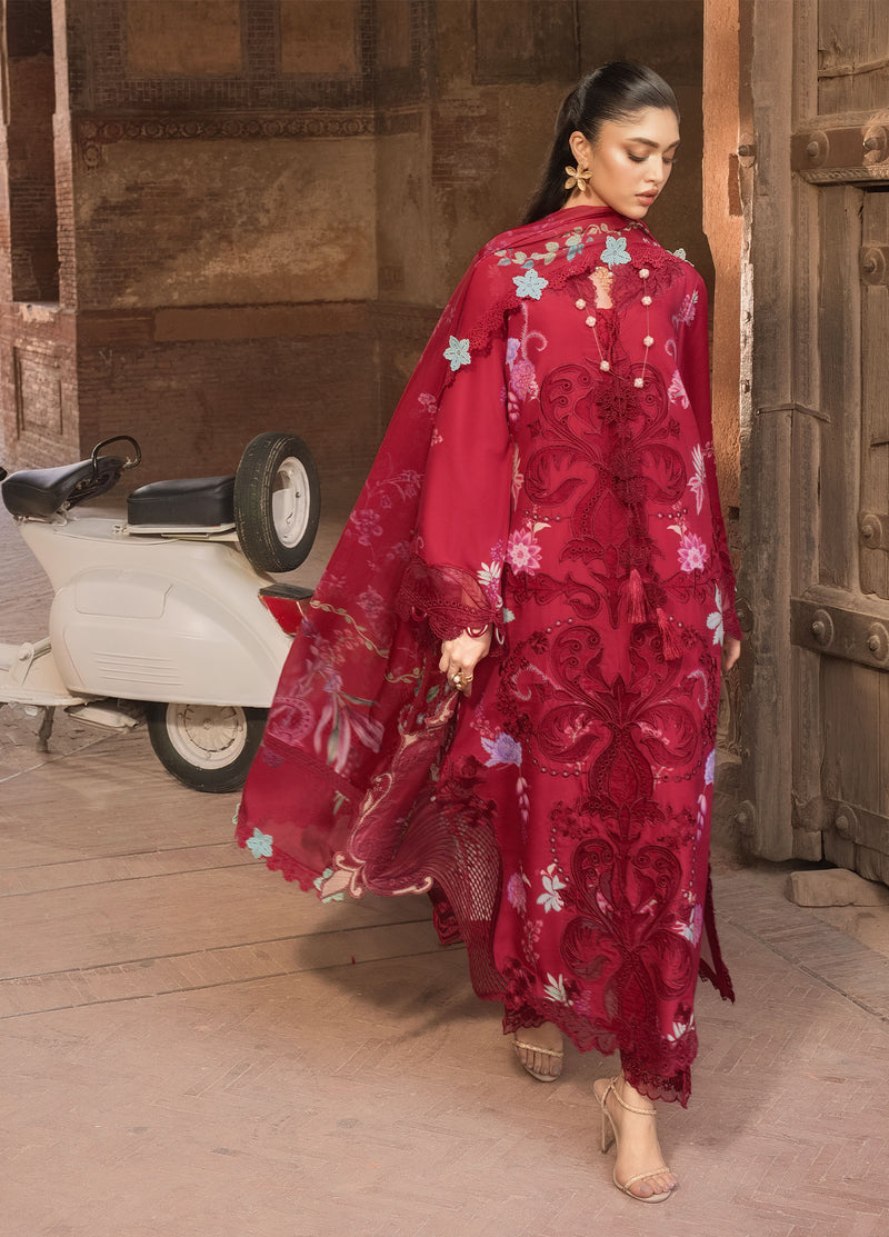 Woman in a red floral dress standing in an indoor setting with a scooter in the background.