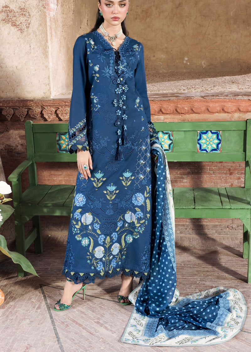 Woman wearing a blue floral dress with a matching dupatta in an indoor setting.