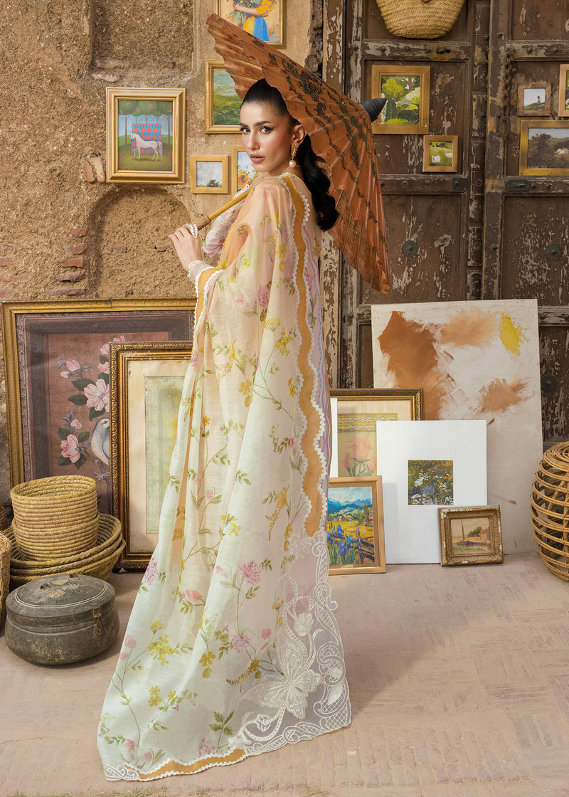 Woman in a floral dress holding an umbrella in a room with framed pictures and baskets.