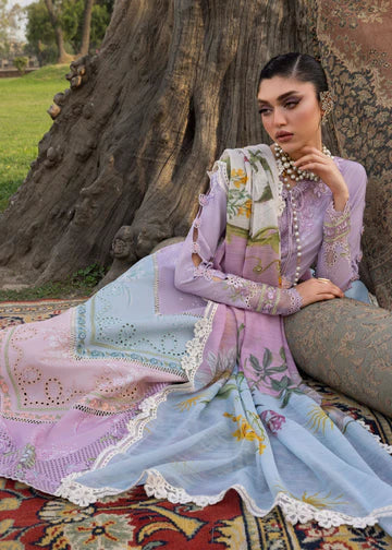 Woman in traditional embroidered outfit sitting on a patterned rug outdoors.