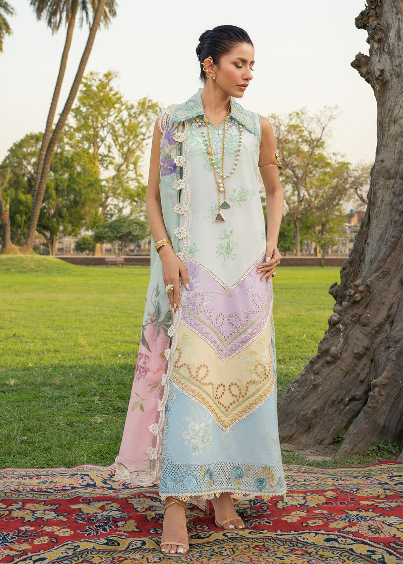 Woman in traditional outfit with floral patterns standing on a rug outdoors.