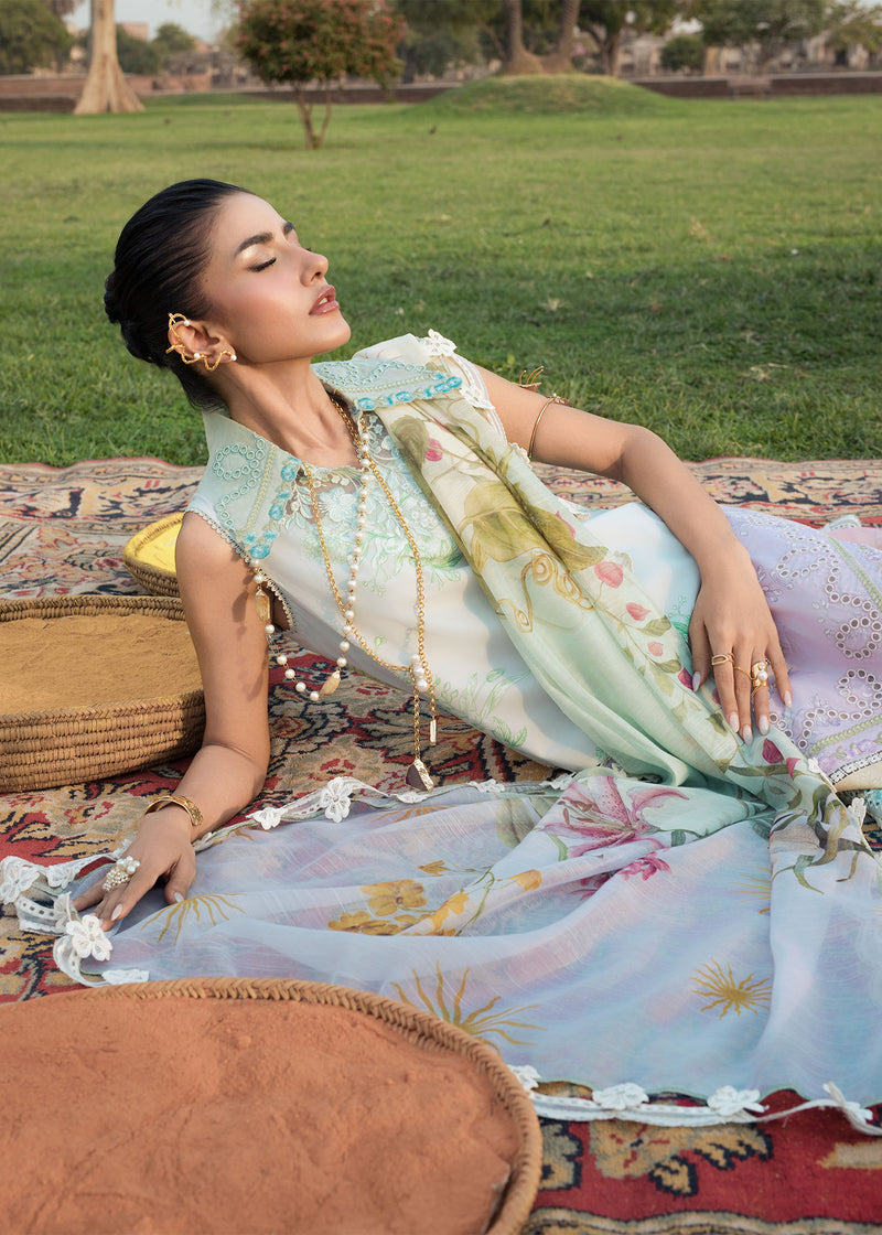 Woman in a floral dress sitting on a patterned rug outdoors