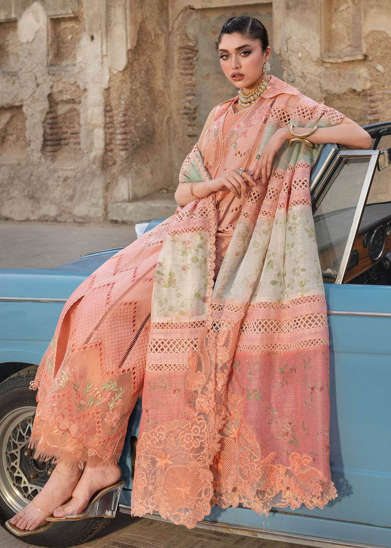 Woman in a traditional outfit sitting on a vintage car with an old building in the background