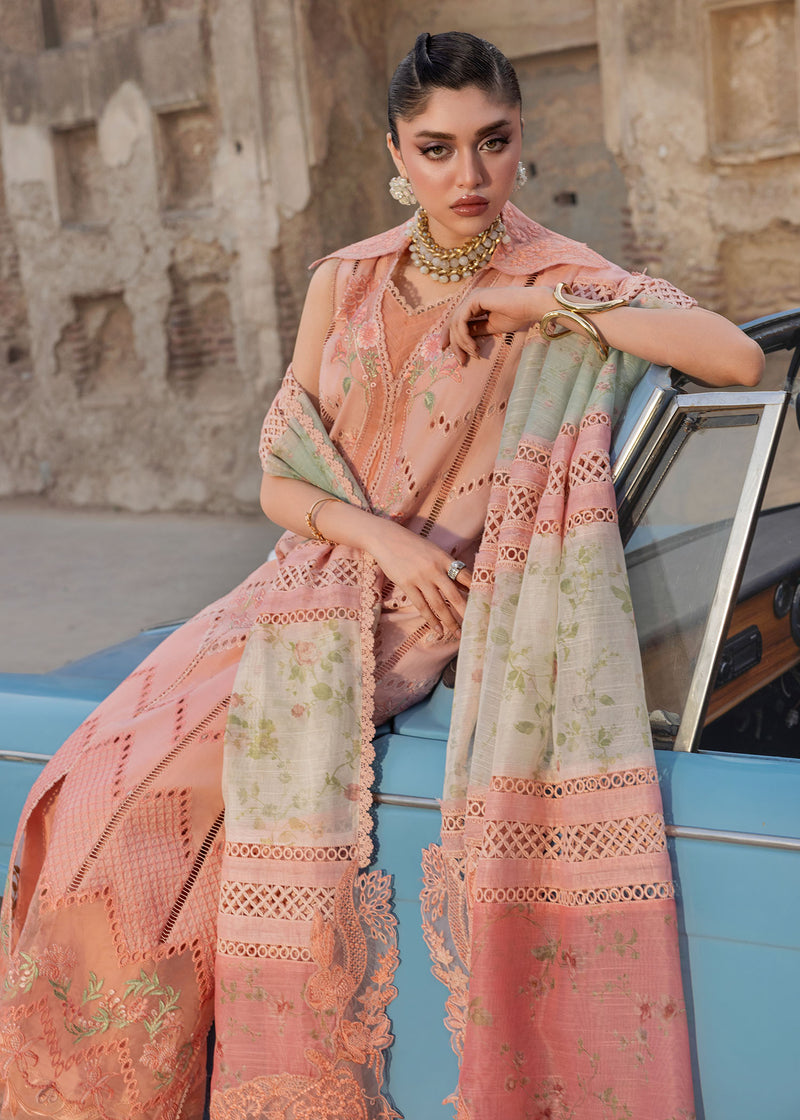 Woman in a traditional outfit with intricate patterns sitting on a vehicle.
