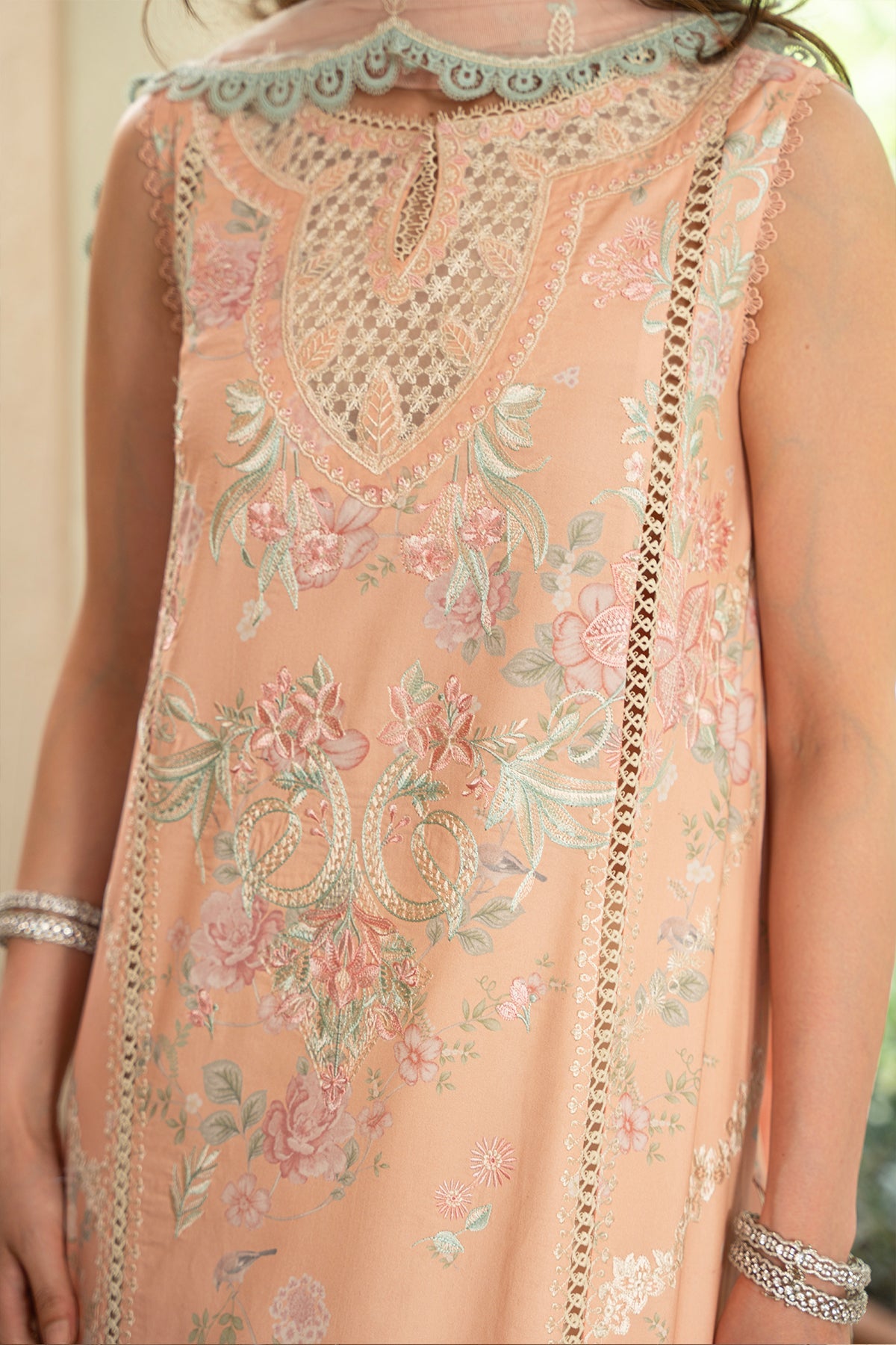 Delicate peach-colored embroidered dress with floral patterns