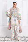 Woman wearing a traditional outfit with a floral design in a white room.