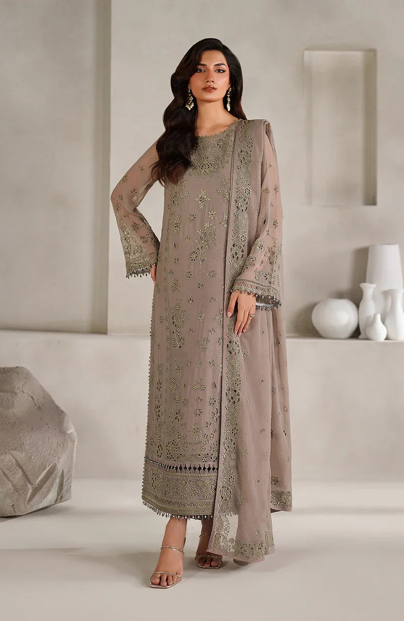 Woman wearing a beige embroidered outfit in a minimalistic setting