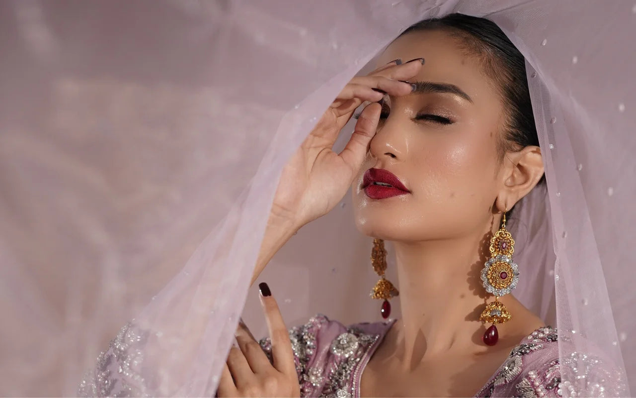 Pakistani woman in a rose gold embroidered bridal outfit with statement jewellery – SURKHAB bridal collection