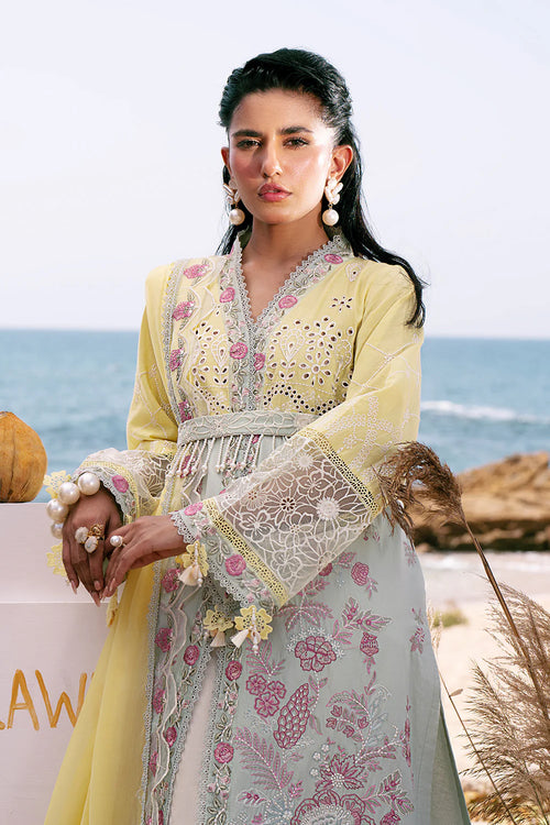 Woman in traditional outfit with ocean in the background