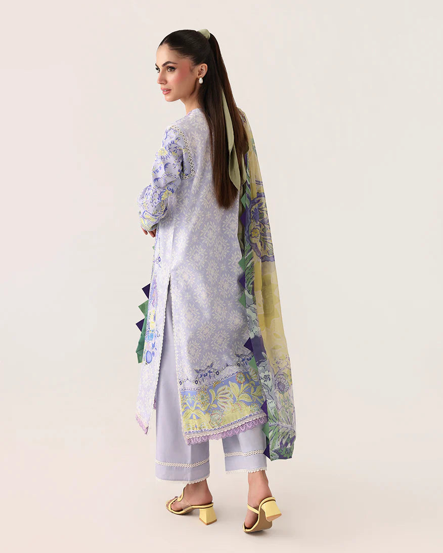 Woman wearing a light gray traditional outfit with floral patterns on a white background