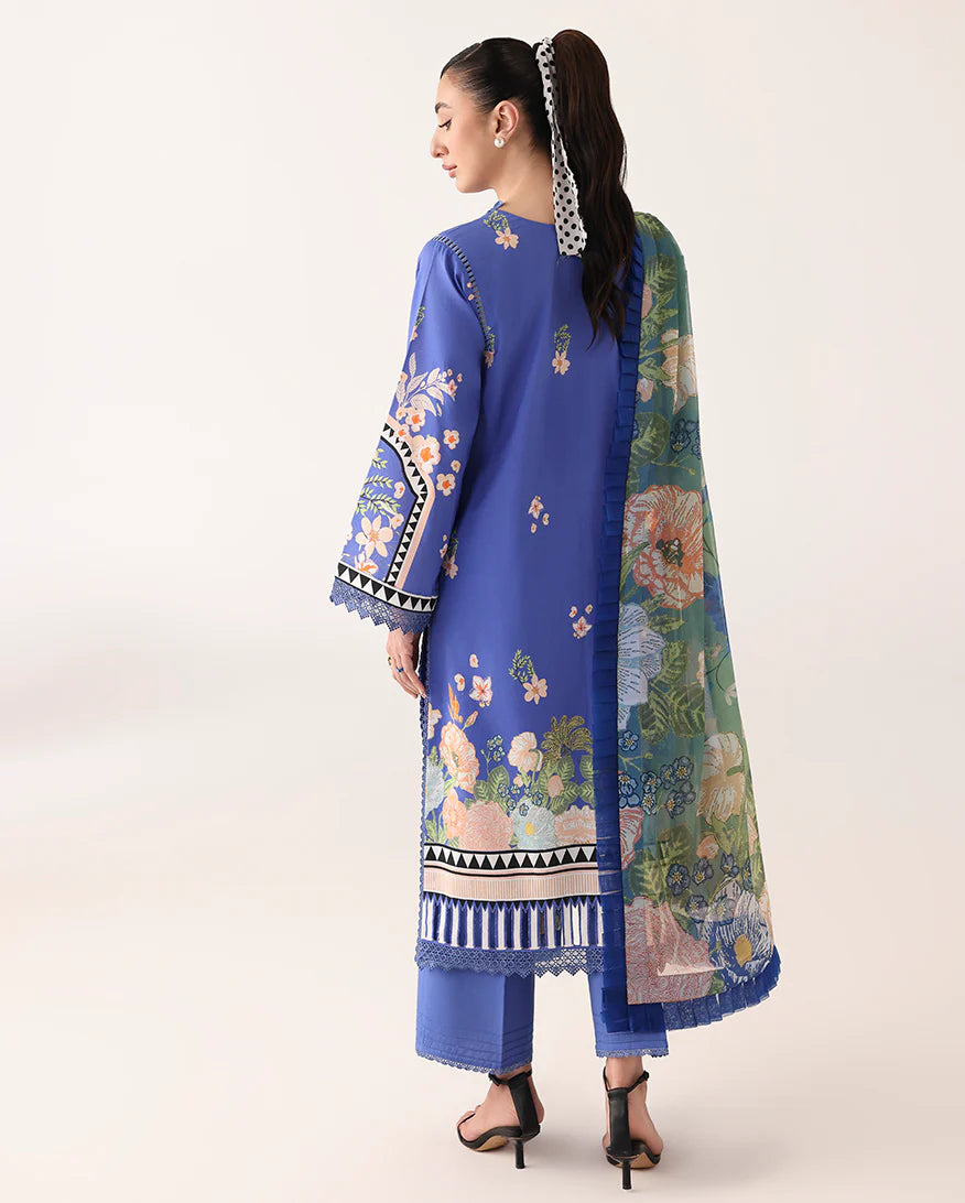 Woman wearing a blue embroidered outfit with a floral patterned dupatta on a white background