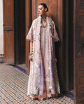 Woman in a floral dress standing in a decorative interior setting