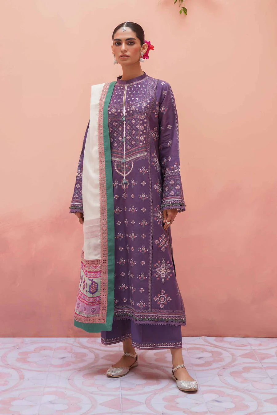 Woman wearing a traditional outfit with a pink background