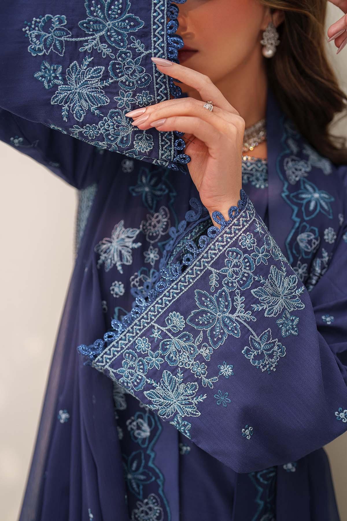 Navy blue embroidered dress with floral patterns on a plain background