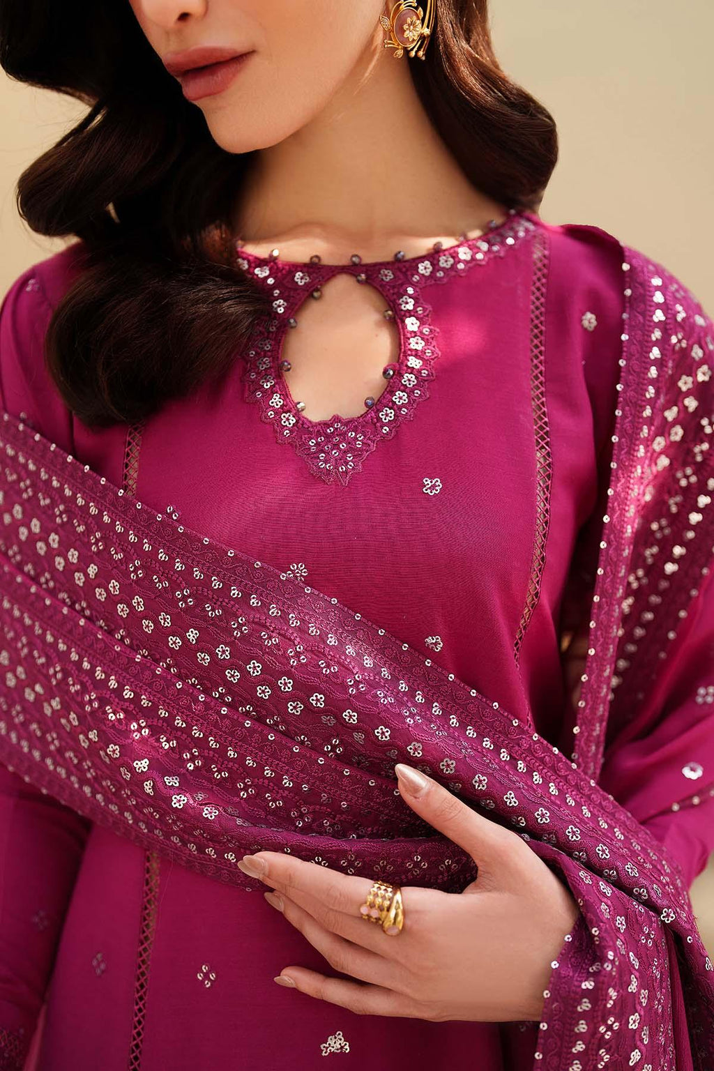 Woman wearing a pink traditional outfit with intricate designs