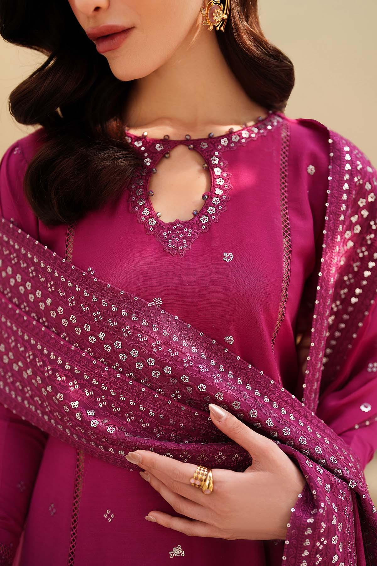 Woman wearing a pink traditional outfit with intricate designs