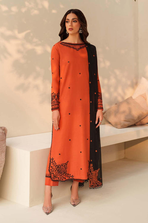 Woman wearing an orange and black traditional outfit with a neutral background