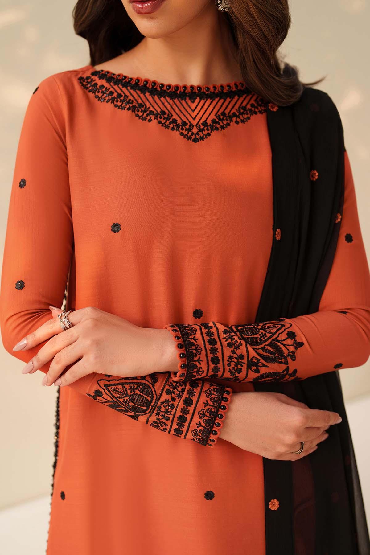 Orange and black embroidered dress with a plain background