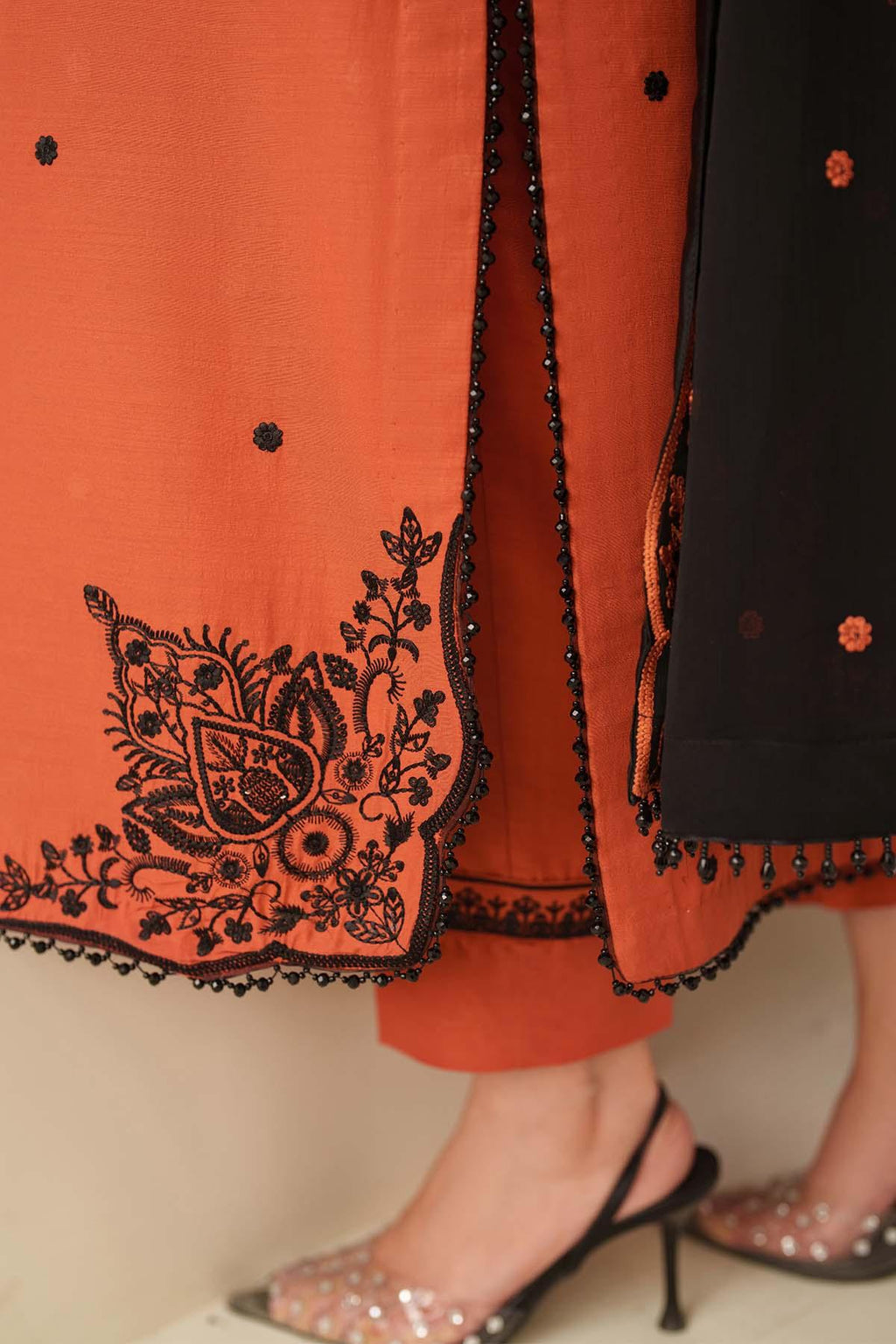 Orange and black traditional outfit with intricate embroidery