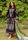 Woman wearing a black and white patterned dress with a green dupatta outdoors.