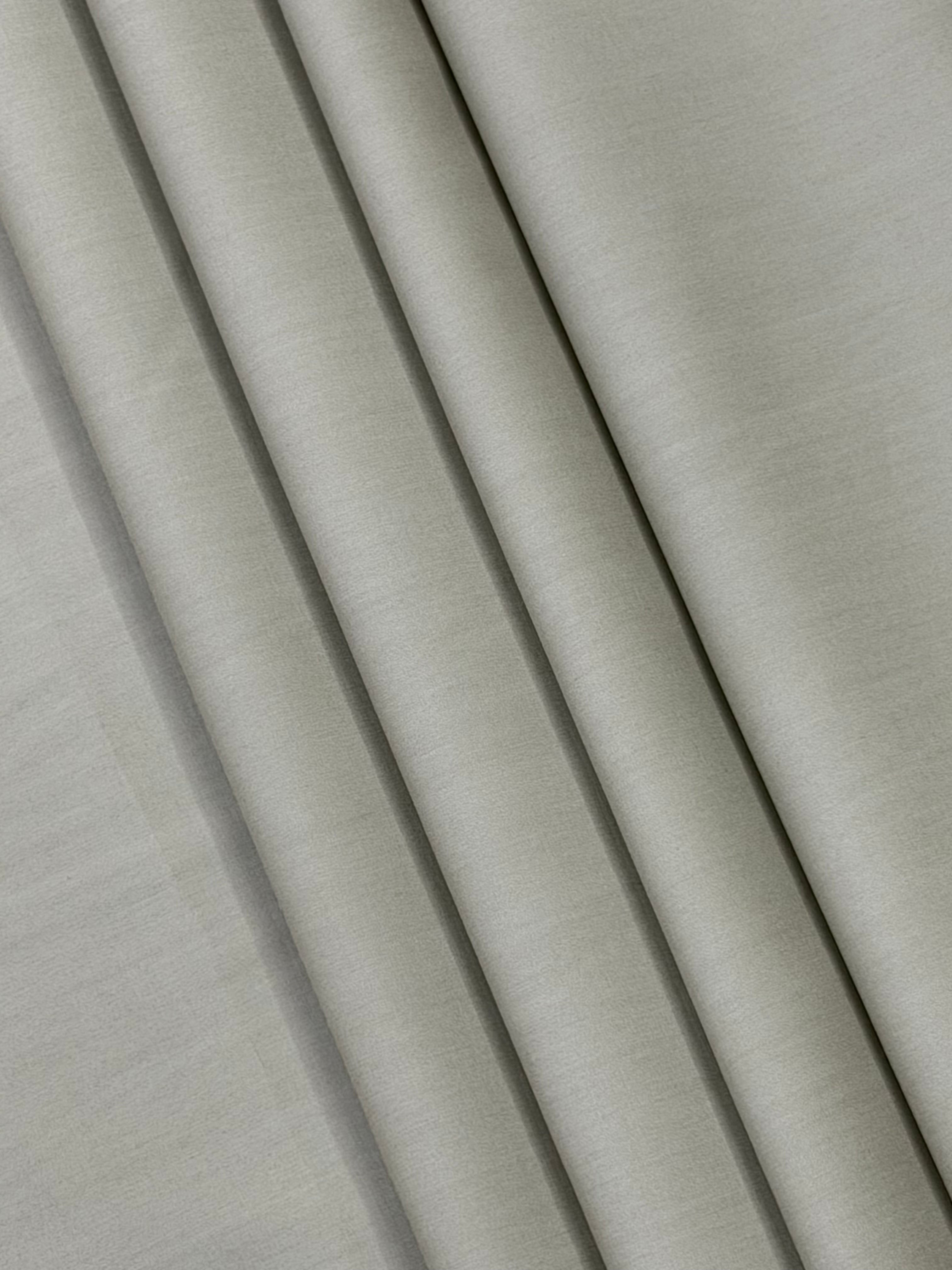 Close-up of beige fabric with folds