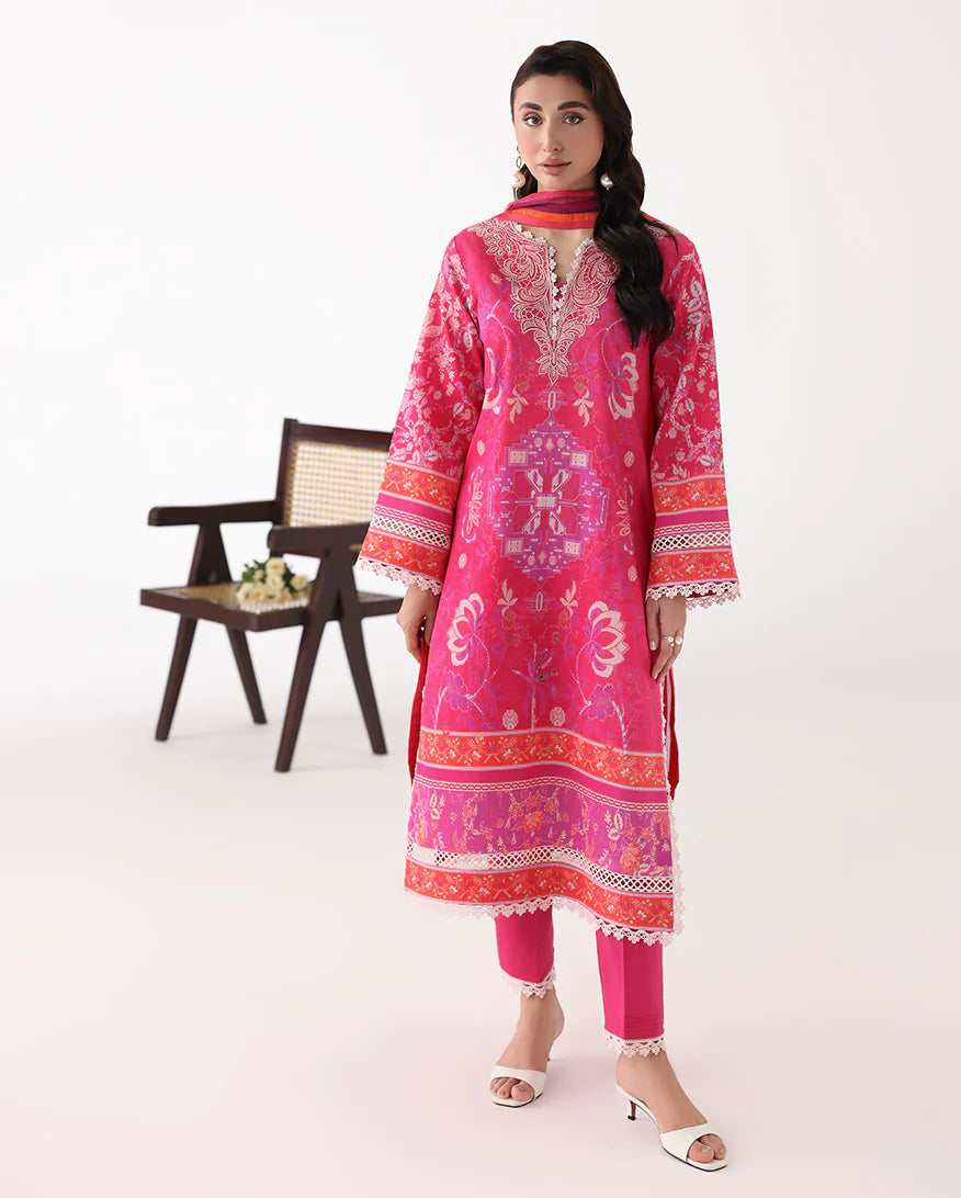 Woman wearing a pink embroidered traditional outfit with a white background