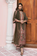 A woman models an olive green traditional kurta set with intricate red and gold embroidery, standing in front of a pink wall and wooden door.