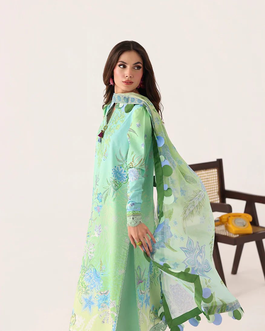 Woman wearing a green floral dress with a white background