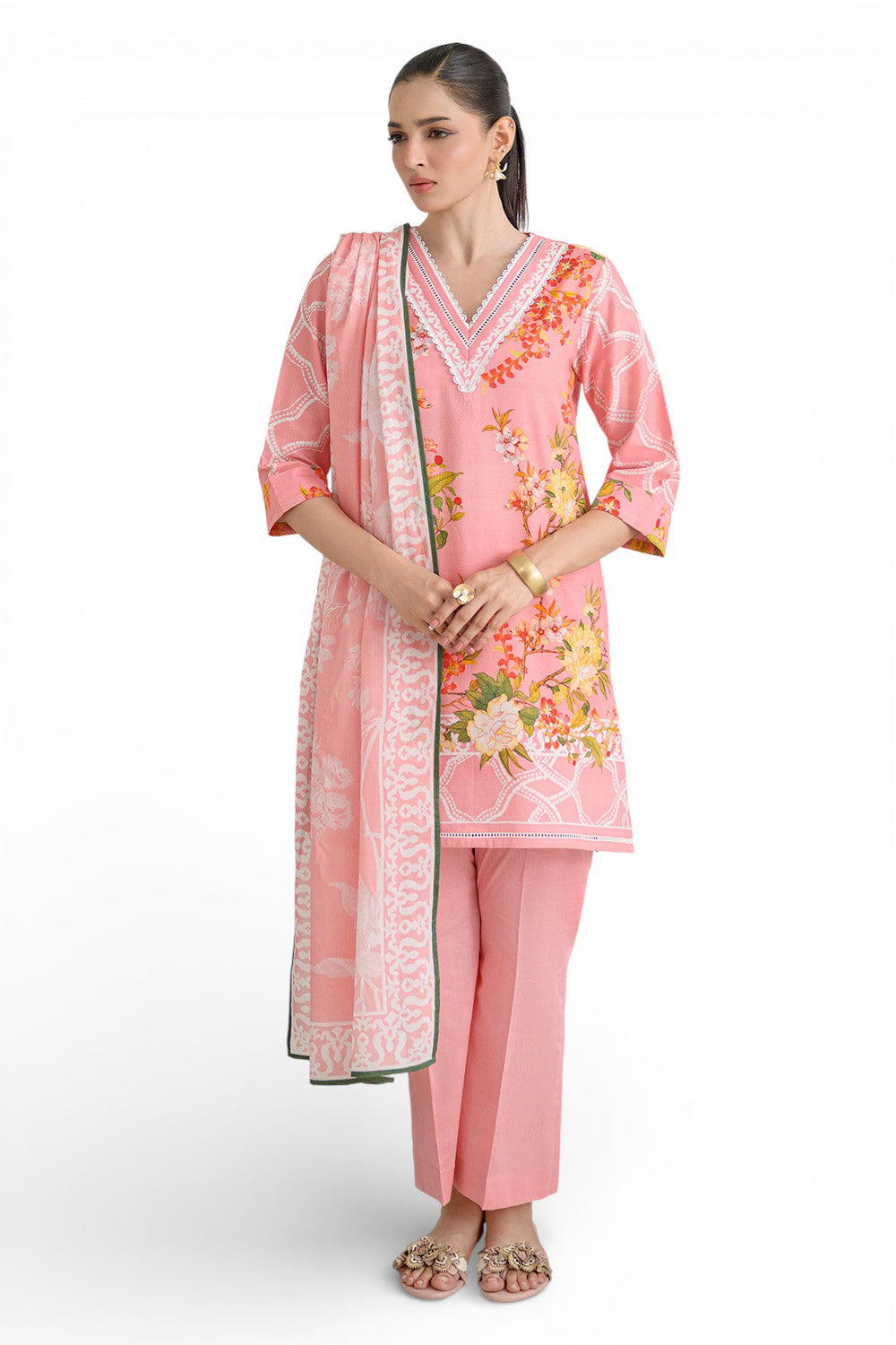 Woman wearing a pink traditional outfit with floral patterns on a white background