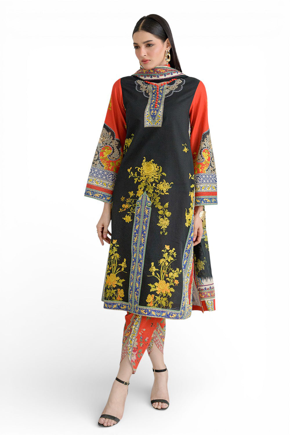 Woman wearing a black and orange embroidered dress with floral patterns on a white background