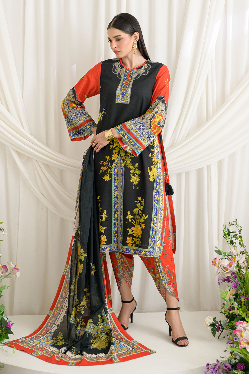 Woman wearing a traditional outfit with floral patterns and a black background