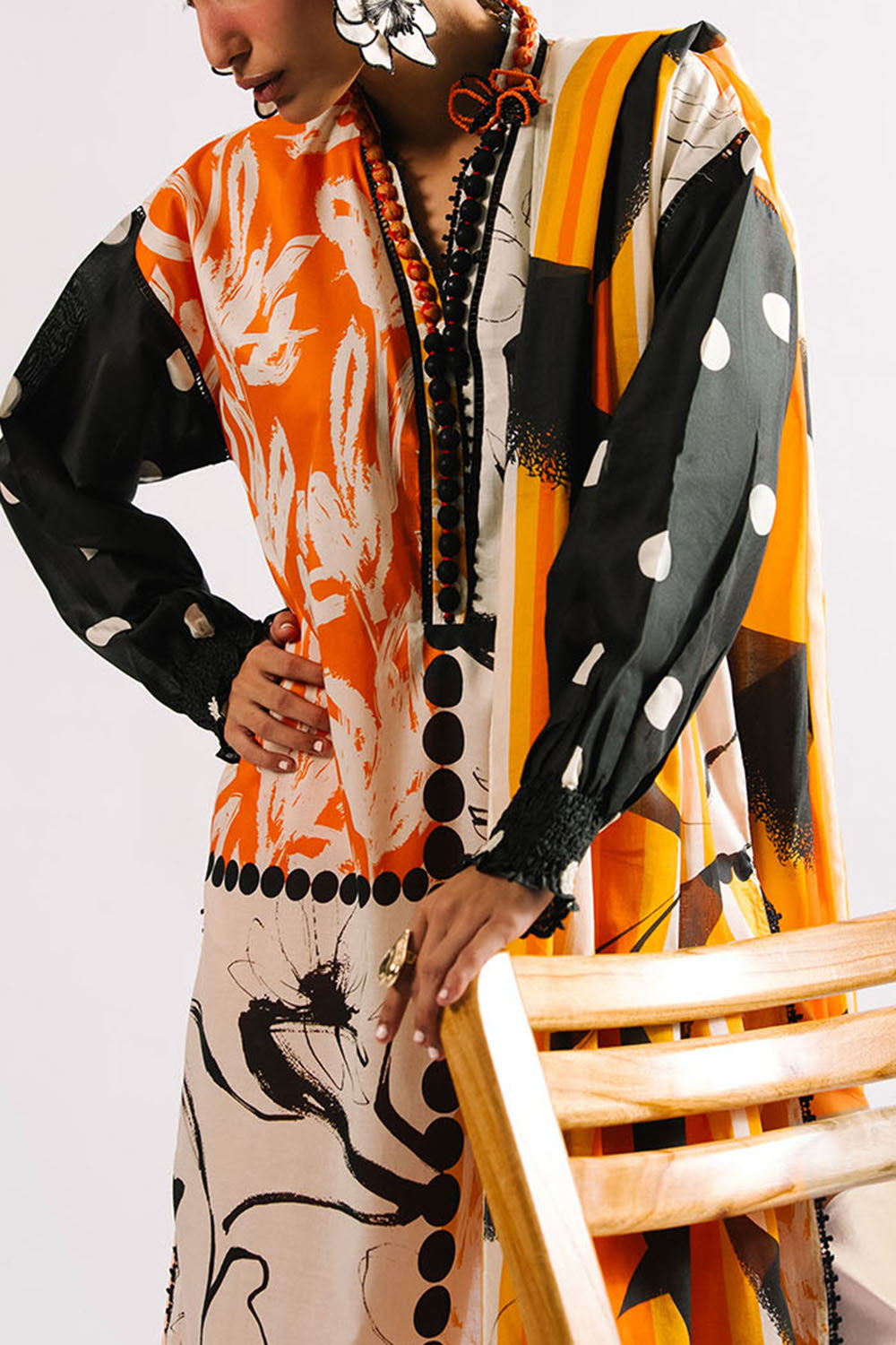 Person wearing a colorful patterned outfit with a white background