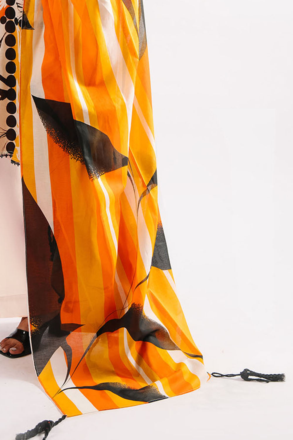 Orange and black patterned scarf on a white background